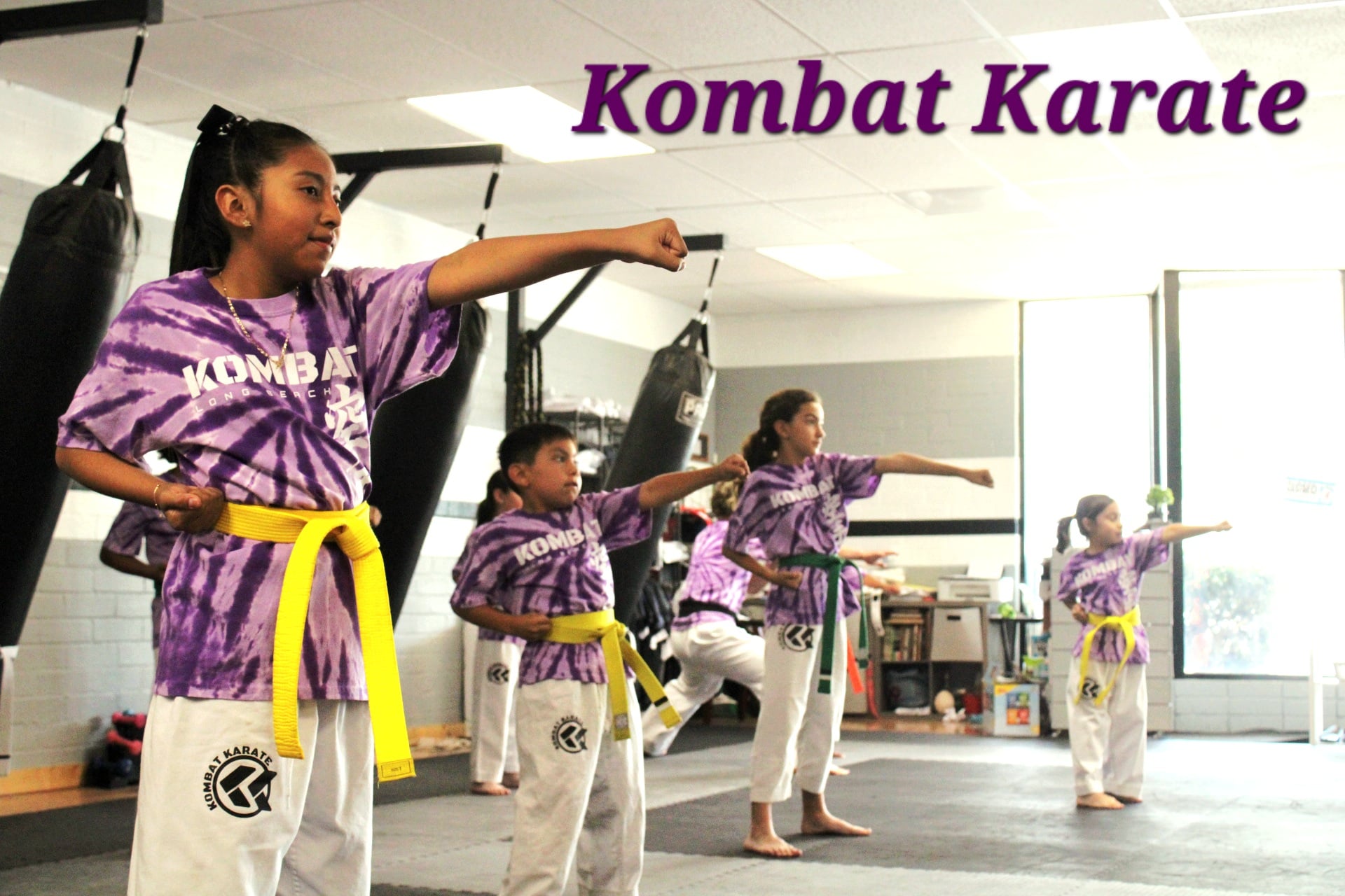 Adult kickboxing student working combinations on focus mitts in Long Beach, CA