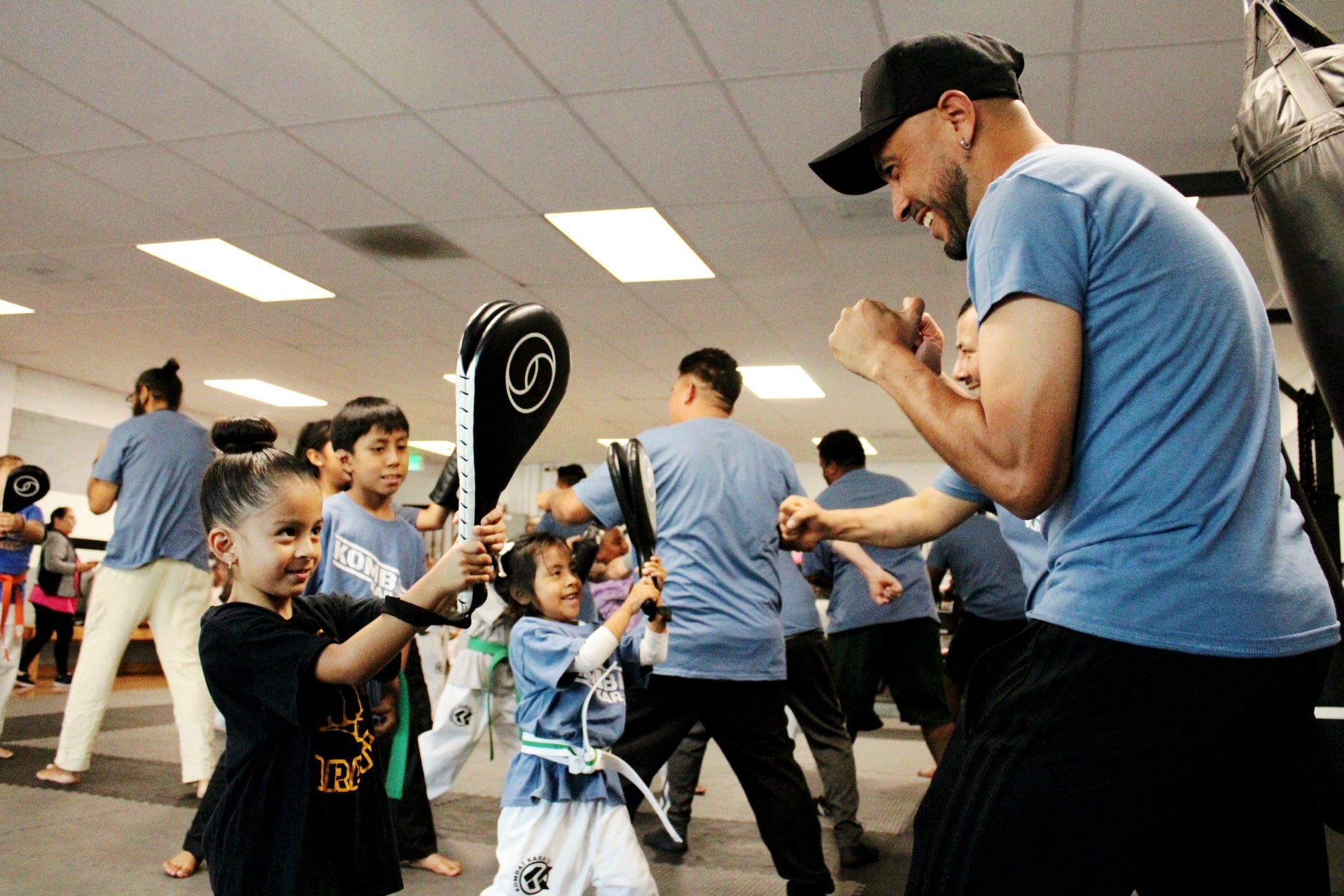 Student receiving a new karate belt from Sensei in Long Beach, CA