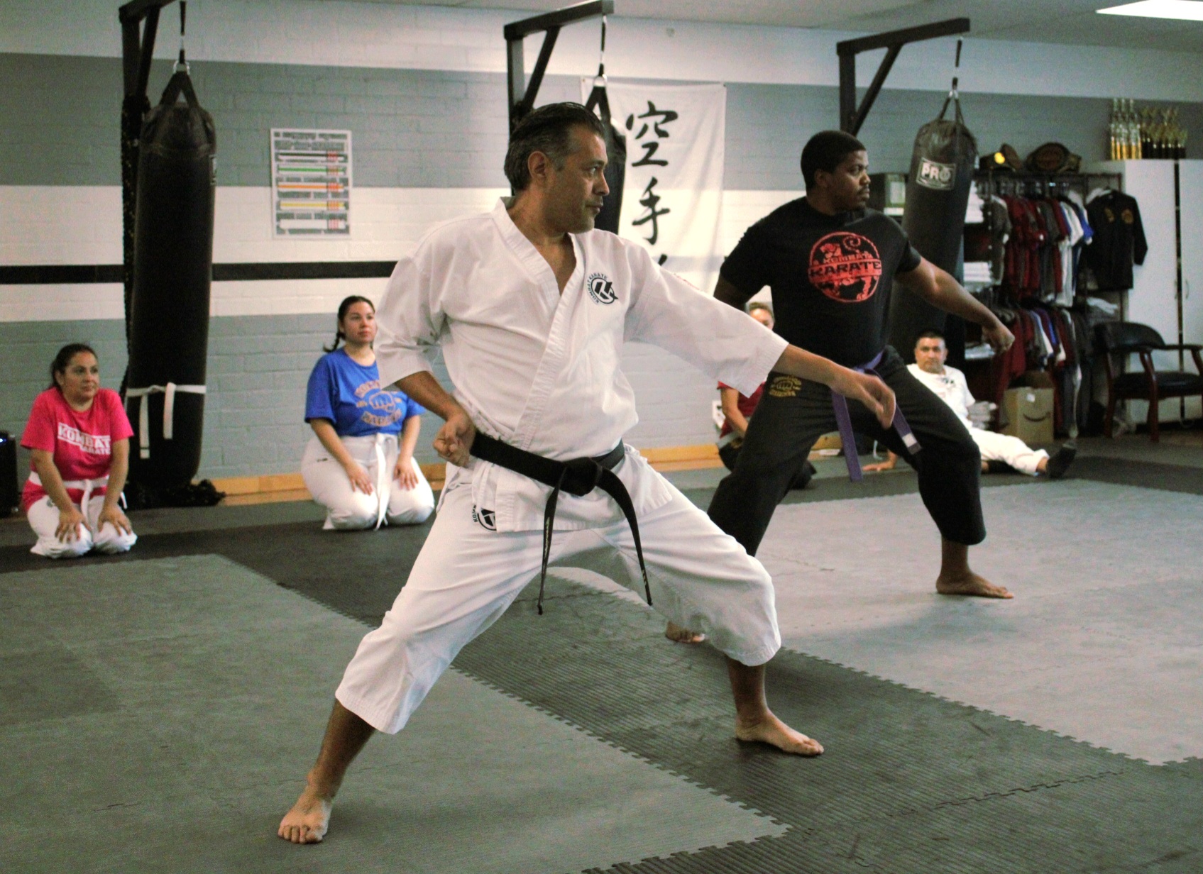 Adult karate students practicing technique at Kombat Karate in Long Beach, CA