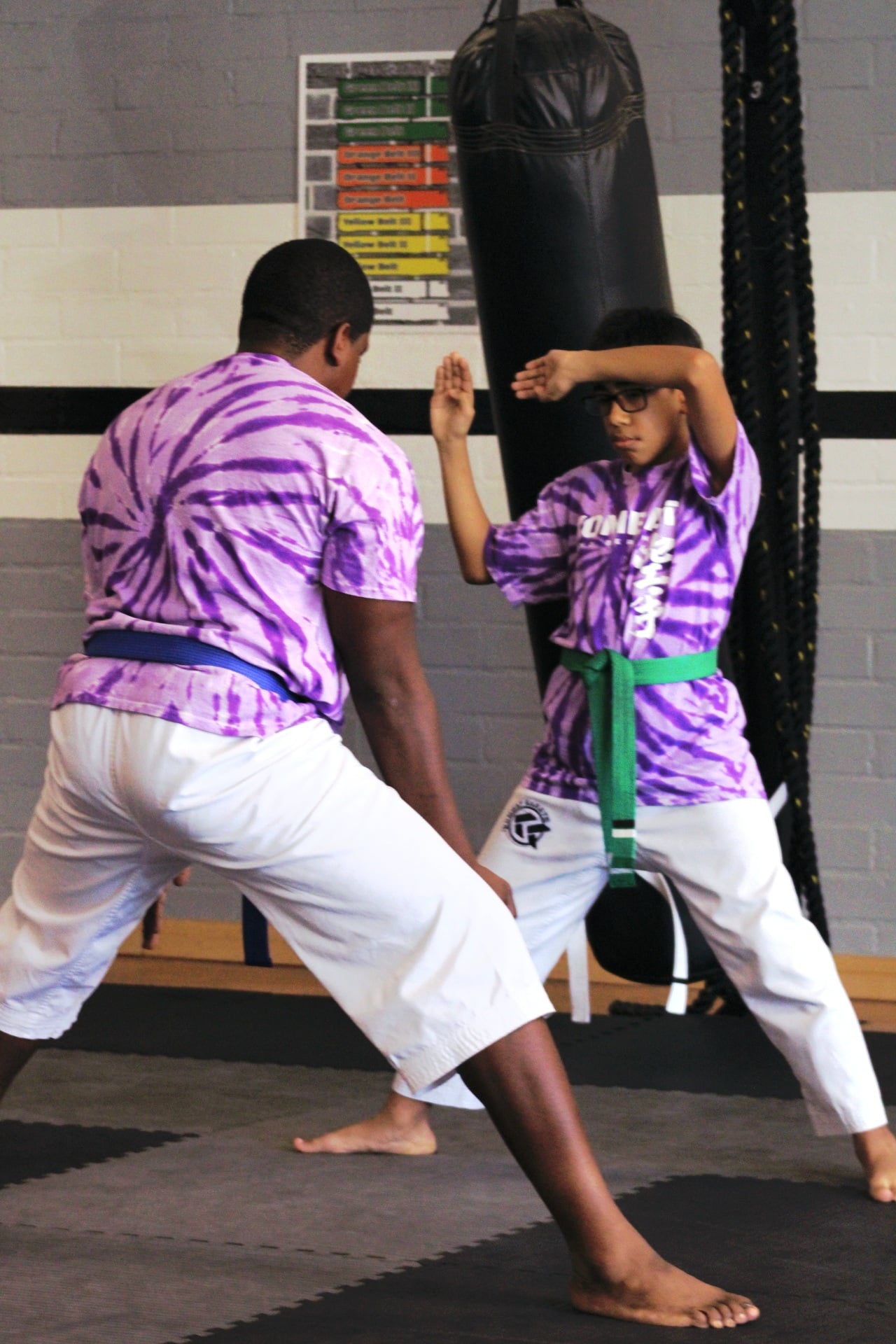 Kids martial arts students smiling with their instructor in Long Beach, CA