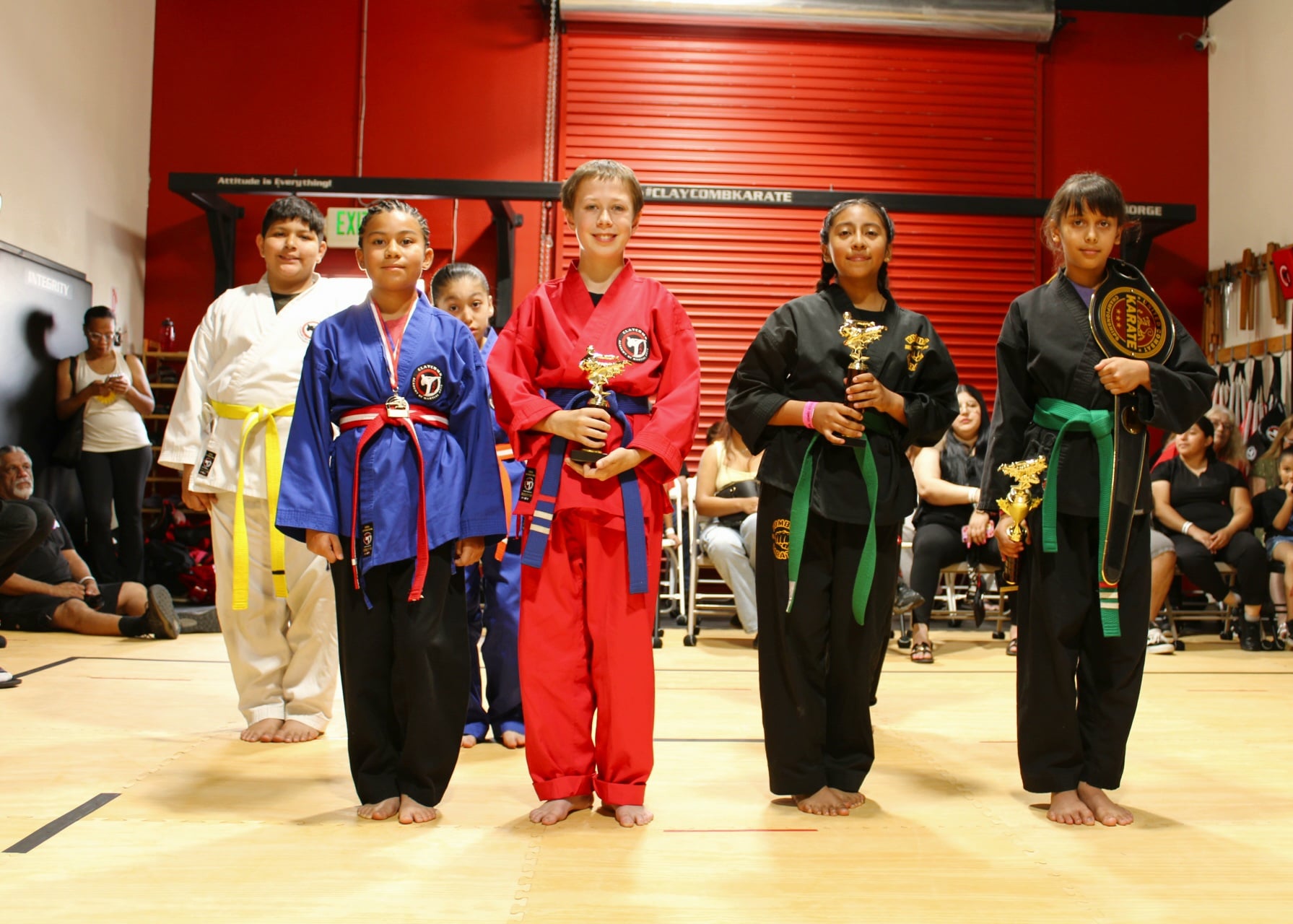 Young karate students practicing kicks during class in Long Beach, CA