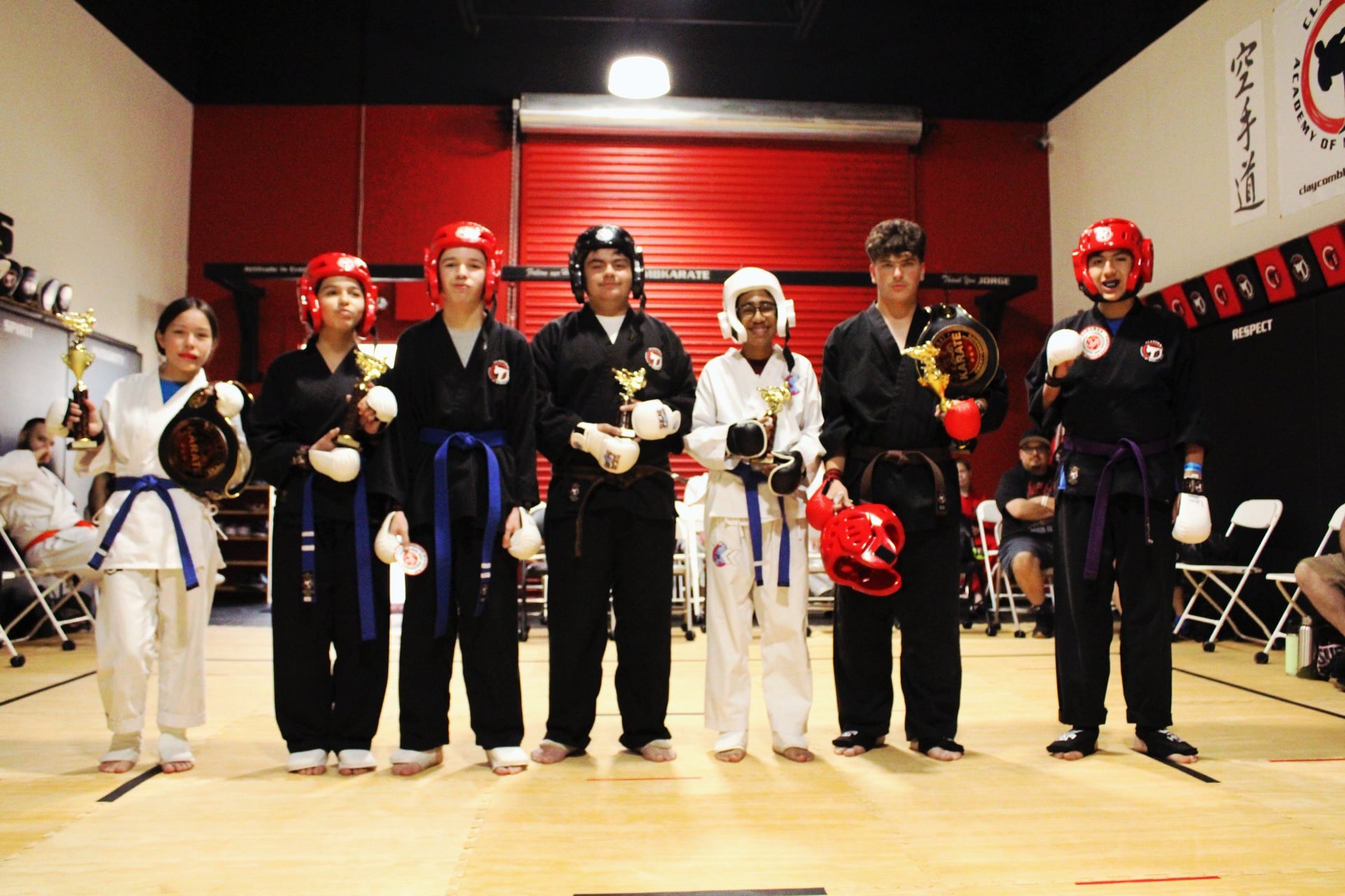 Kombat Karate family celebrating a belt promotion ceremony